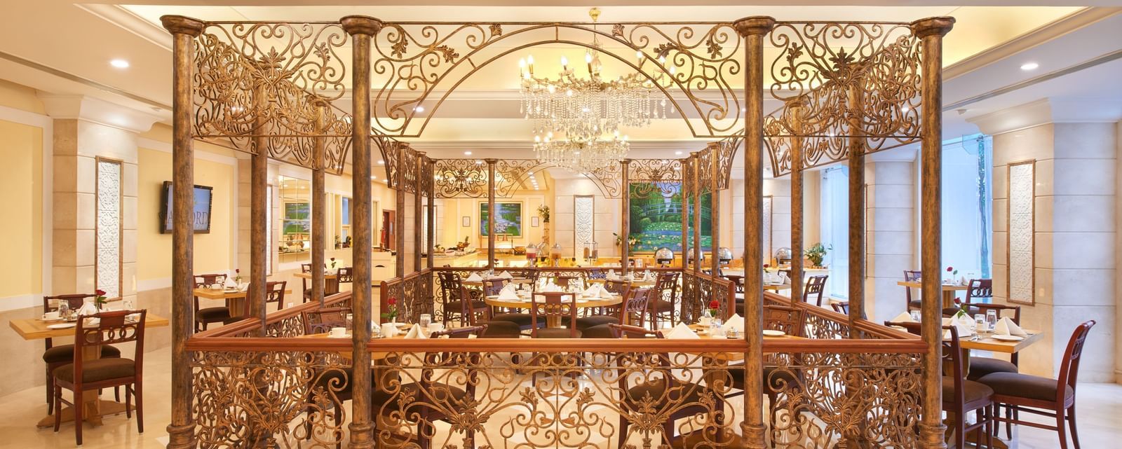 An image of a sectioned dining area with dining tables and chairs at Accord Puducherry